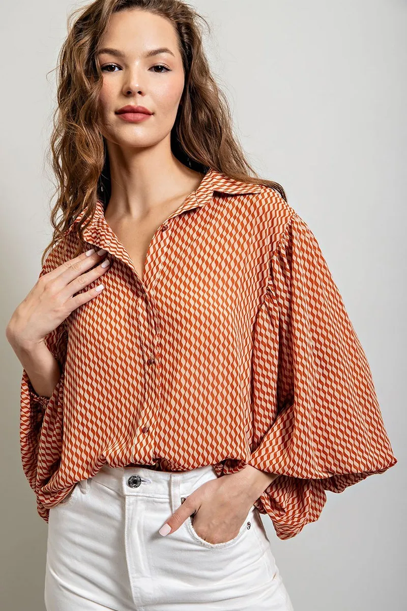Printed blouse top with collared neckline, button down front, and smocked cuffs