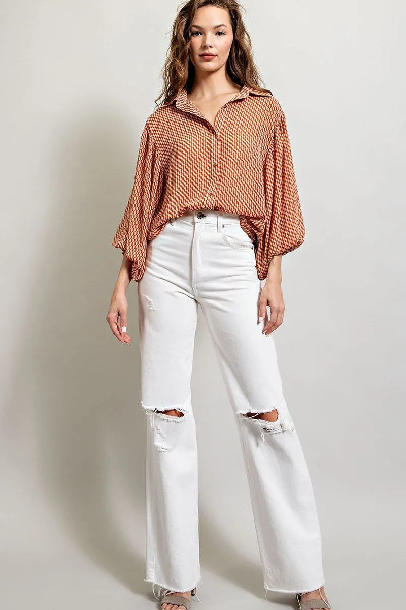 Printed blouse top with collared neckline, button down front, and smocked cuffs